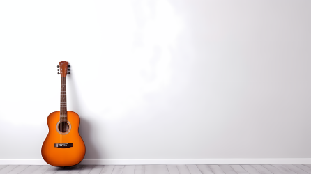 橘色木吉他竖立在极简白色房间摄影图片