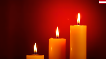 红色背景上三支燃烧的蜡烛摄影图片