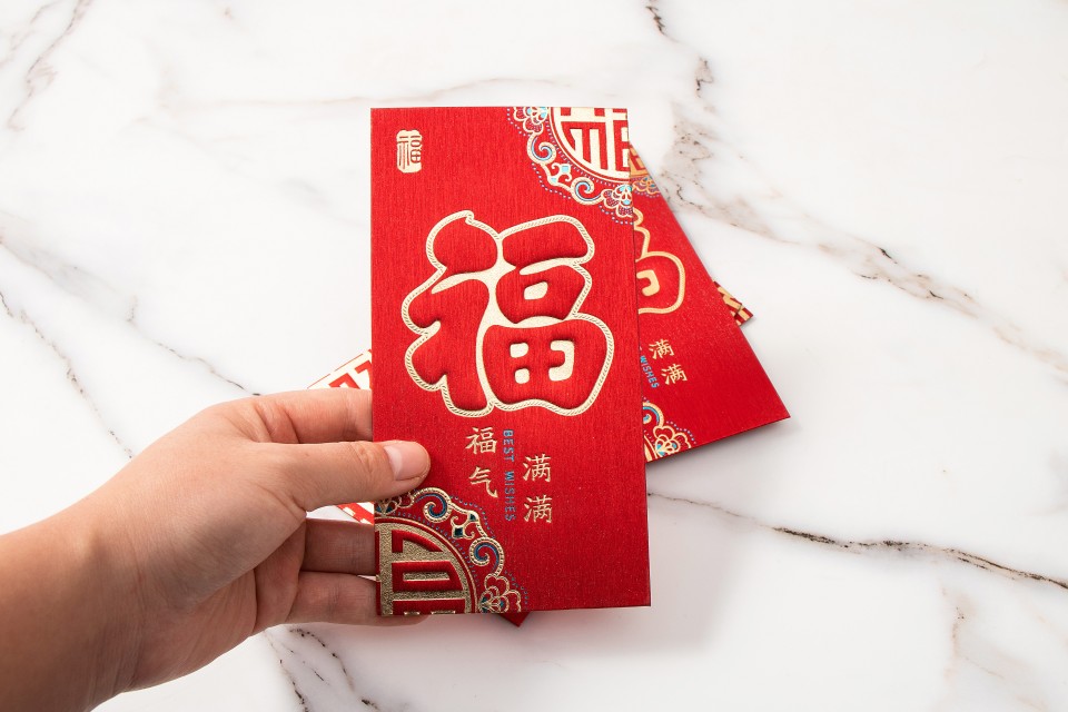 大理石背景手拿福气红包实拍图