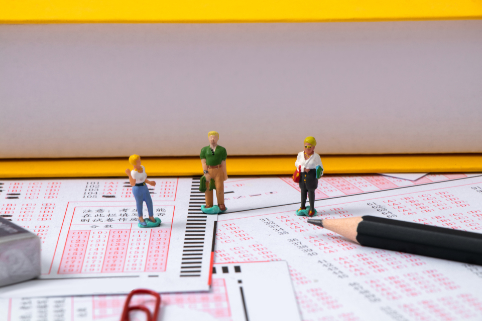 小人玩偶站在答题卡上高清图