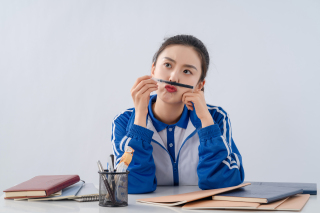 在课堂上坐着玩笔的女生高清图