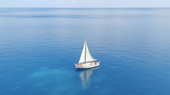 生态旅游蓝色海洋上的白帆船摄影图