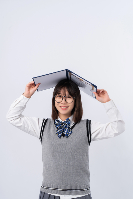 头顶荣誉证书开心大笑的学生实拍图