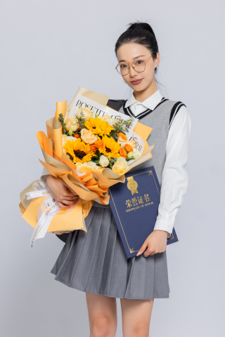 左手拿着花站着的大学生写真图