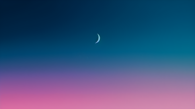 月亮在暮色中升起的弯月摄影图