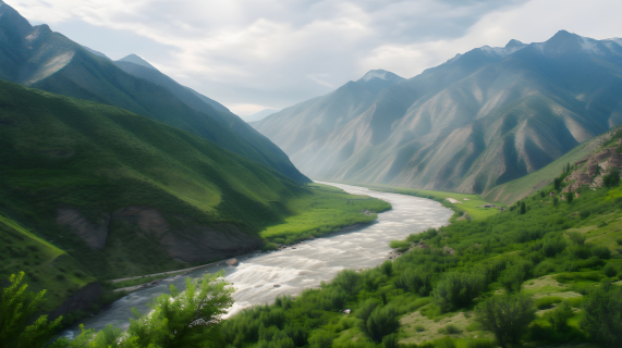 山谷中的河流，绿草覆盖的山丘和背景中的山脉摄影图片