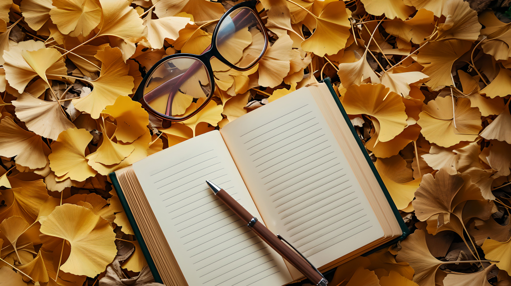 书本学习银杏叶飘落的摄影图片