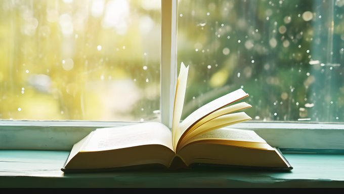 翻开的书本和窗景摄影图